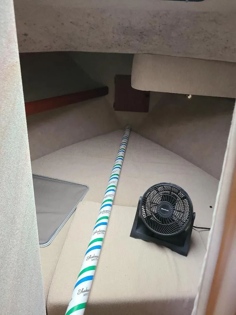 Slide: The Image of 1989 Bayliner 3255 Avanti cabin interior with fan and striped pole. - 9