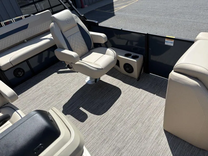 Slide: The Image of 2025 Godfrey Sweetwater 2486 SFLC boat interior with beige seating and cup holders. - 11