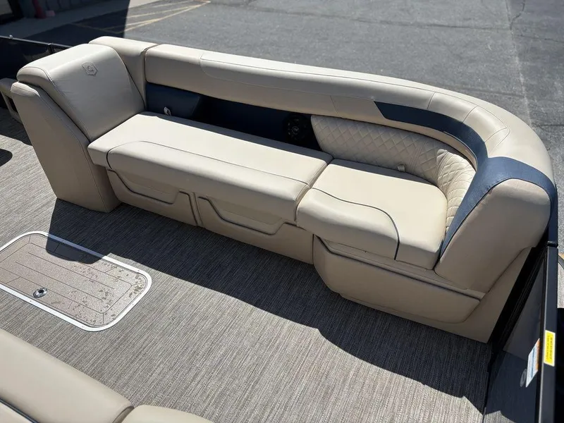 Slide: The Image of 2025 Godfrey Sweetwater 2486 SFLC boat interior with beige seating and carpeted flooring. - 14