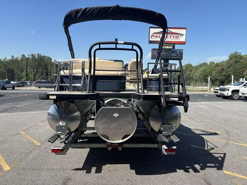 Slide: The Image of 2025 Godfrey Sweetwater 2486 SFLC pontoon boat, rear view, parked outdoors. - 20