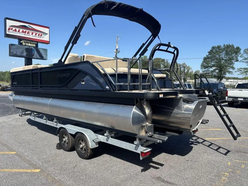 Slide: The Image of 2025 Godfrey Sweetwater 2486 SFLC pontoon boat on trailer, parked outdoors. - 21