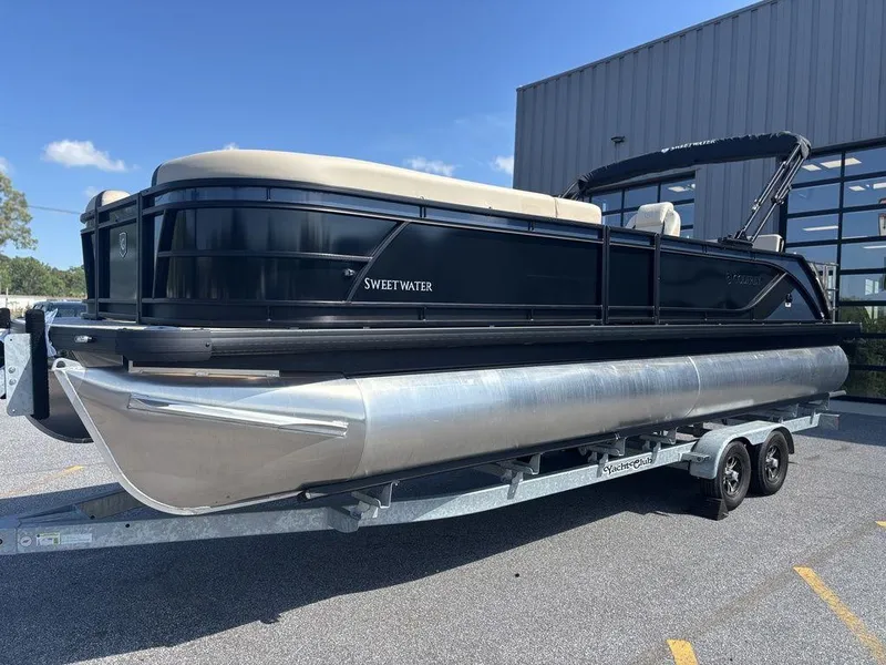 Slide: The Image of 2025 Godfrey Sweetwater 2486 SFLC pontoon boat on trailer, parked outdoors. - 22