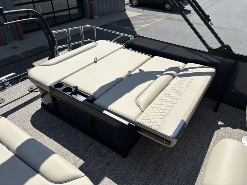 Slide: The Image of 2025 Godfrey Sweetwater 2486 SFLC boat interior with beige seating and cup holders. - 3