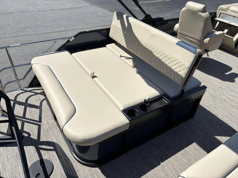 Slide: The Image of 2025 Godfrey Sweetwater 2486 SFLC boat interior with beige seating and cup holders. - 5