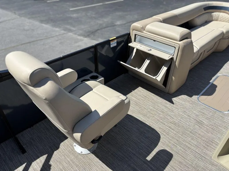 Slide: The Image of 2025 Godfrey Sweetwater 2486 SFLC boat interior with beige seating and storage compartments. - 6