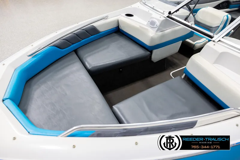 Slide: The Image of Interior of 1993 Excel 20SX boat with blue and gray seating, Reeder-Trausch Marine logo. - 10