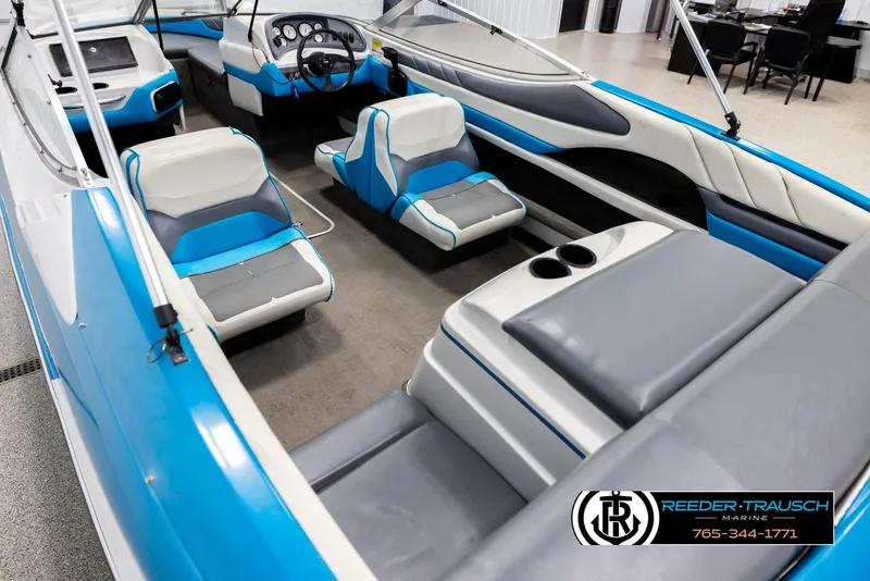 Slide: The Image of 1993 Excel 20SX boat interior with blue and gray seating, steering wheel, and dashboard. - 11