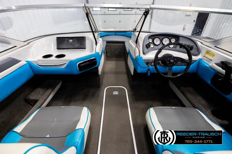 Slide: The Image of Interior of a 1993 Excel 20SX boat with blue and white seating. - 14