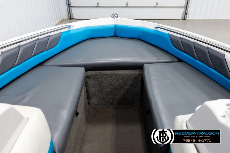 Slide: The Image of Interior of a 1993 Excel 20SX boat with blue and gray seating. - 15