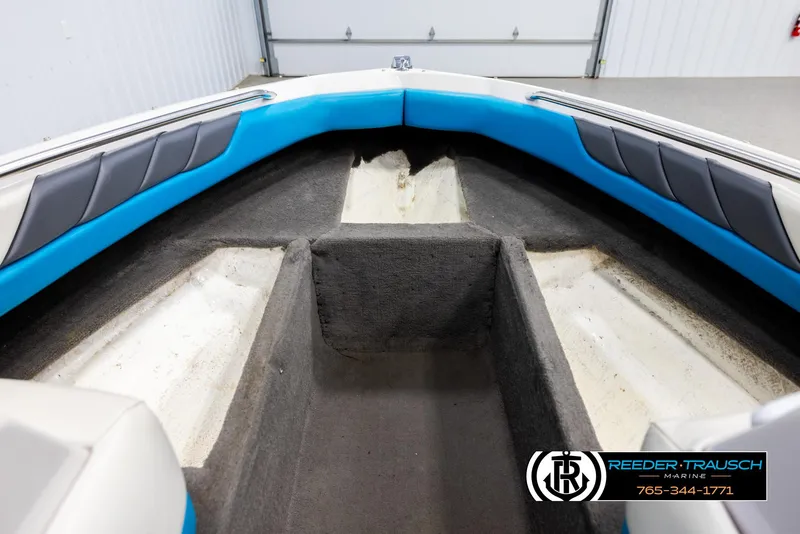 Slide: The Image of Interior of 1993 Excel 20SX boat with blue and gray seating, Reeder-Trausch Marine logo. - 16