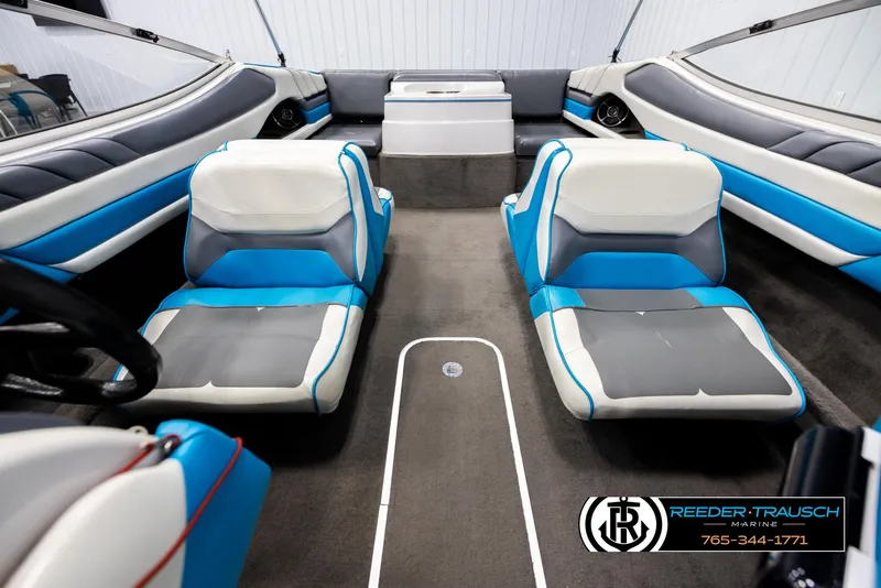 Slide: The Image of Interior of a 1993 Excel 20SX boat with blue and white seating. - 18