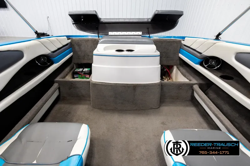 Slide: The Image of Interior of a 1993 Excel 20SX boat with seating and storage compartments. - 20