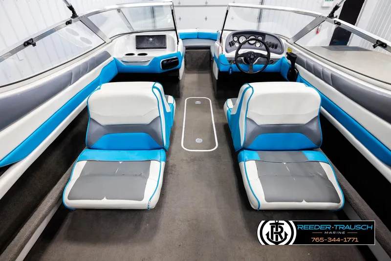 Slide: The Image of Interior of a 1993 Excel 20SX boat with blue and white seating. - 21