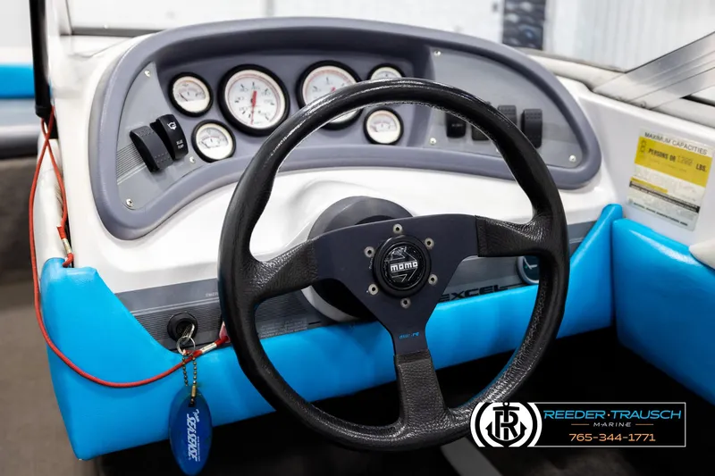 Slide: The Image of 1993 Excel 20SX boat dashboard with steering wheel and gauges. - 24