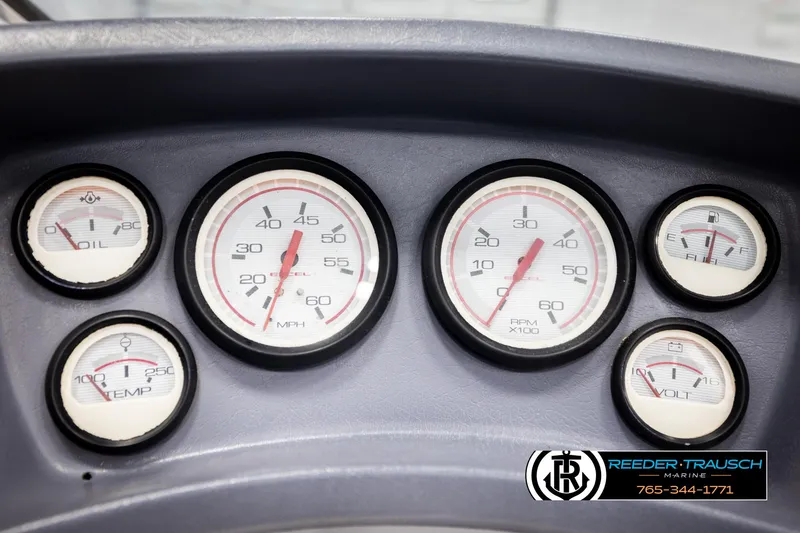 Slide: The Image of Dashboard gauges of a 1993 Excel 20SX boat, showing speed, fuel, oil, and temperature. - 27