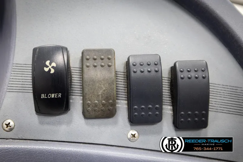 Slide: The Image of Dashboard controls of a 1993 Excel 20SX boat, featuring blower switch and buttons. - 28