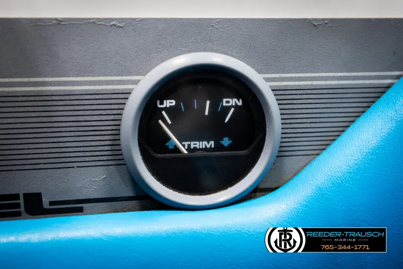 Slide: The Image of Trim gauge on 1993 Excel 20SX boat dashboard, showing up and down indicators. - 29