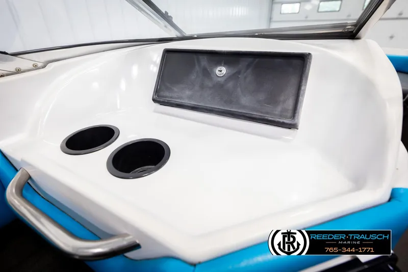 Slide: The Image of 1993 Excel 20SX boat dashboard with cup holders and storage compartment. - 31