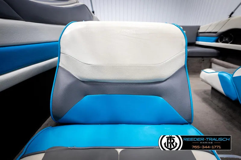 Slide: The Image of 1993 Excel 20SX boat interior with blue and white seating, featuring Reeder-Trausch Marine branding. - 33