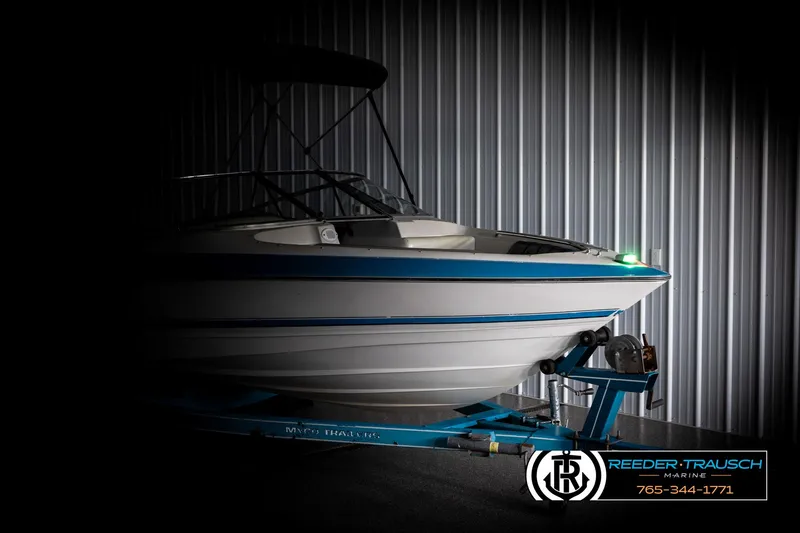 Slide: The Image of 1993 Excel 20SX boat on trailer in dimly lit storage facility. - 4