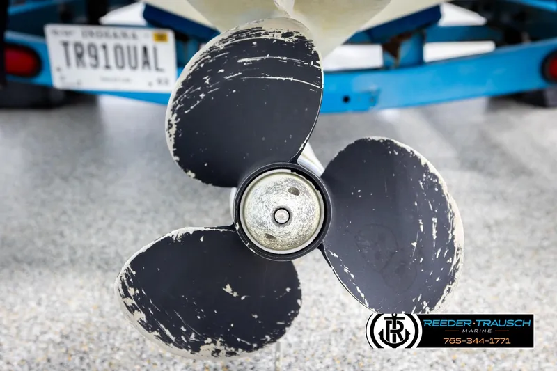 Slide: The Image of Propeller of 1993 Excel 20SX boat with visible wear, license plate in background. - 43