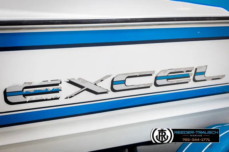 Slide: The Image of 1993 Excel 20SX boat logo with blue and white design, Reeder-Trausch Marine branding. - 44