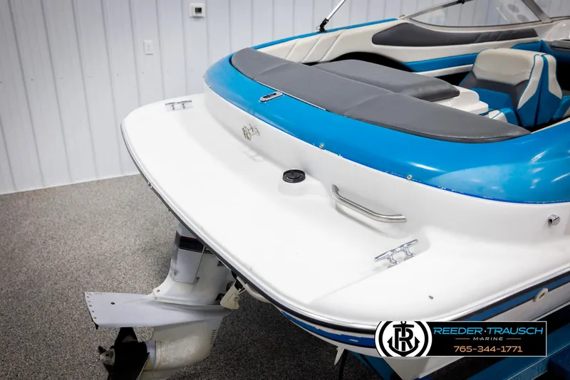 Slide: The Image of 1993 Excel 20SX boat, blue and white, rear view in showroom. - 45