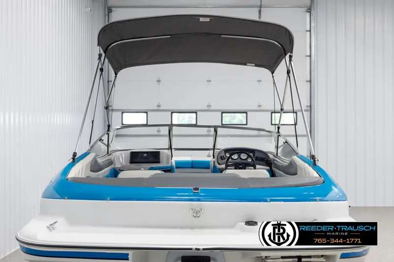 Slide: The Image of 1993 Excel 20SX boat with canopy in a garage, rear view. - 7