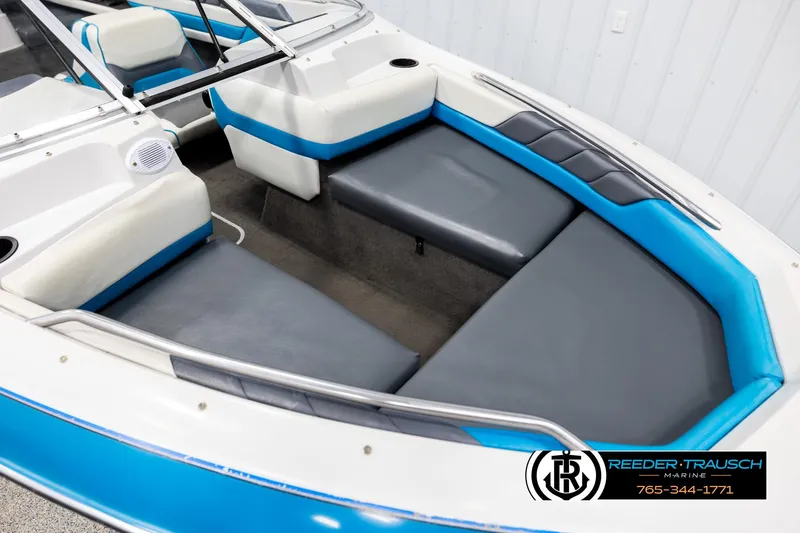 Slide: The Image of 1993 Excel 20SX boat interior with blue and gray seating, Reeder-Trausch Marine logo. - 9