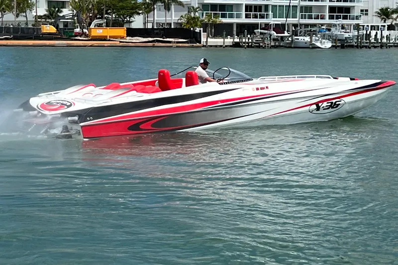 Slide: The Image of 2004 Spectre 36 Cat speedboat with red and white design cruising on water. - 1