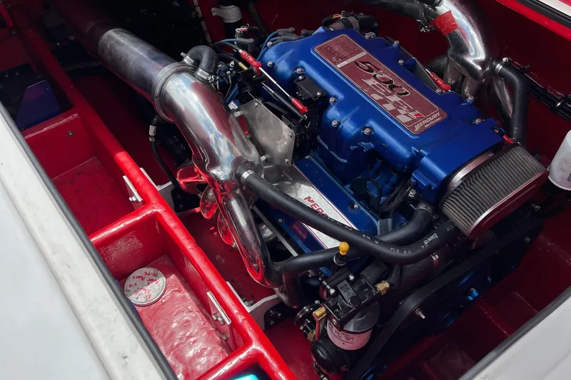 Slide: The Image of Engine of a 2004 Spectre 36 Cat boat, featuring a powerful blue motor setup. - 11