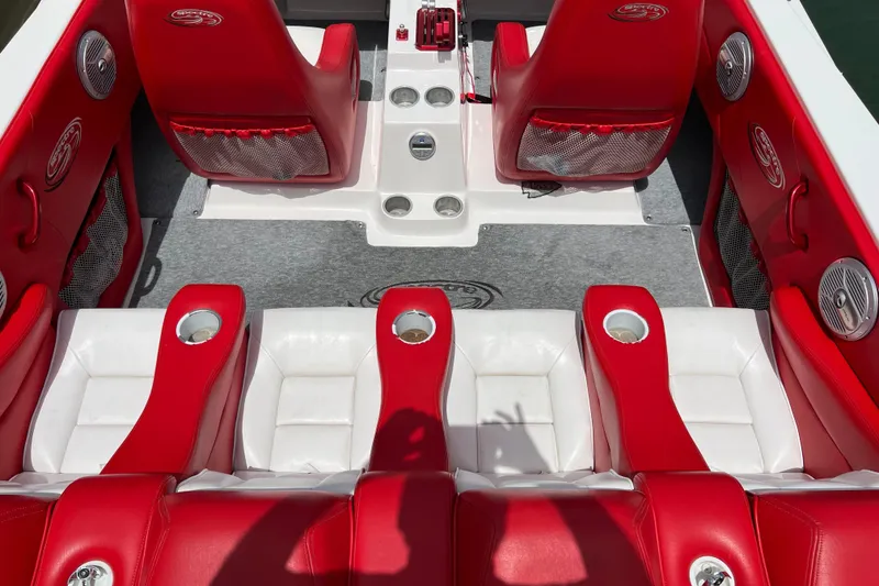 Slide: The Image of 2004 Spectre 36 Cat boat interior with red and white seating, cup holders, and speakers. - 12