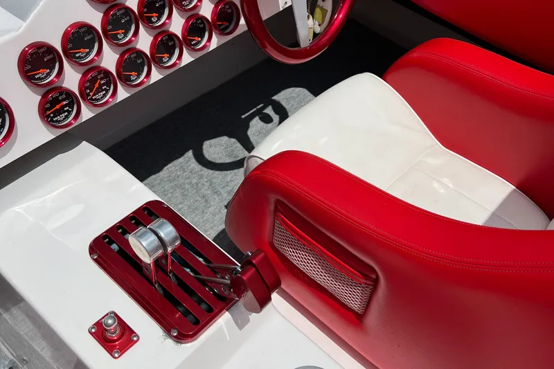 Slide: The Image of Interior of 2004 Spectre 36 Cat boat with red and white seats and multiple gauges. - 14