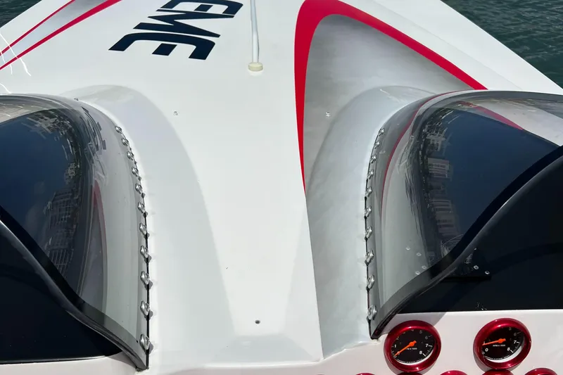 Slide: The Image of 2004 Spectre 36 Cat boat with sleek design and red accents on deck. - 15