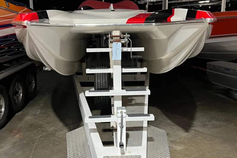 Slide: The Image of 2004 Spectre 36 Cat boat on trailer, viewed from the front in a garage setting. - 19