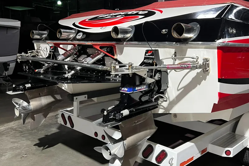 Slide: The Image of 2004 Spectre 36 Cat boat with dual propellers and vibrant red, black, and white design. - 21