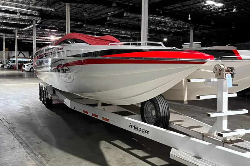 Slide: The Image of 2004 Spectre 36 Cat powerboat on trailer in warehouse, red and white design. - 26