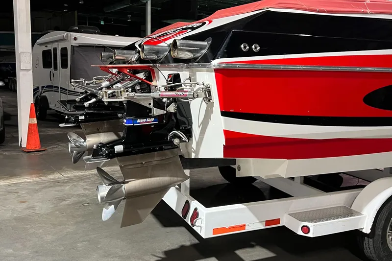 Slide: The Image of 2004 Spectre 36 Cat boat with vibrant red and black design, parked indoors. - 27