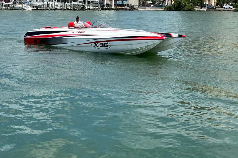 Slide: The Image of 2004 Spectre 36 Cat powerboat on calm water, featuring sleek red and white design. - 4