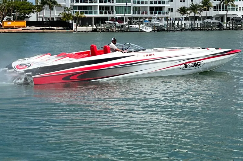 Slide: The Image of 2004 Spectre 36 Cat powerboat cruising on water, featuring sleek red and white design. - 5