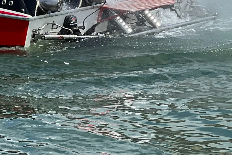 Slide: The Image of 2004 Spectre 36 Cat boat on water, showcasing rear section and wake. - 6