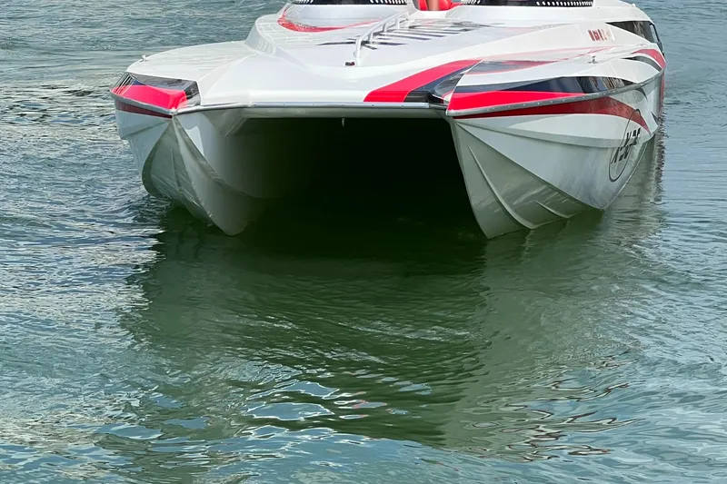 Slide: The Image of 2004 Spectre 36 Cat powerboat with red accents on water. - 8