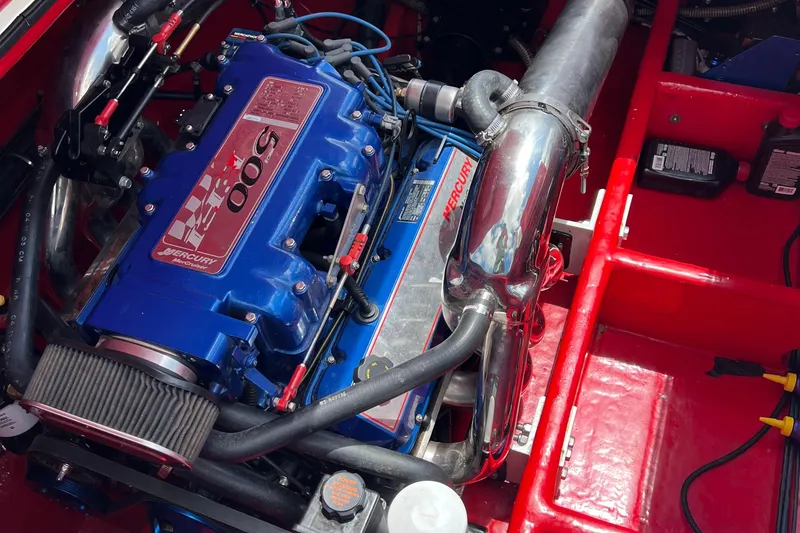 Slide: The Image of 2004 Spectre 36 Cat engine, featuring a powerful blue Mercury 500 EFI motor. - 9