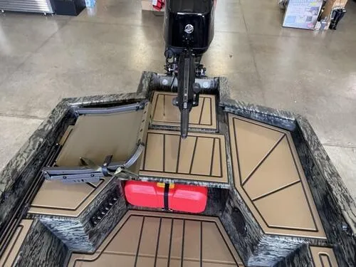 Slide: The Image of 2025 Tracker Grizzly 1650 T Prairie Wings Edition boat interior with motor and storage compartments. - 7