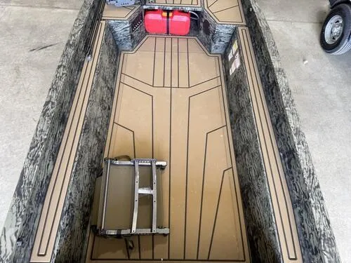 Slide: The Image of 2025 Tracker Grizzly 1650 T Prairie Wings Edition boat interior with camo design and storage space. - 9