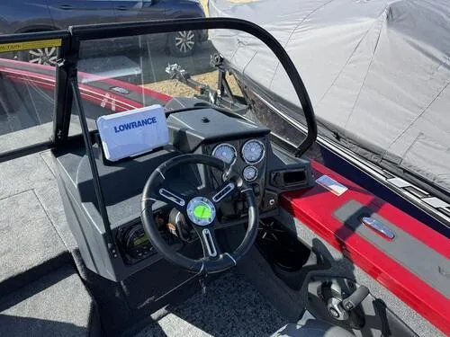 Slide: The Image of 2025 Tracker Targa V-18 WT boat dashboard with Lowrance display and steering wheel. - 10