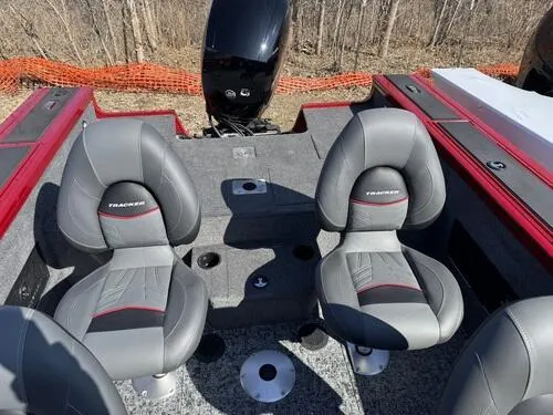 Slide: The Image of 2025 Tracker Targa V-18 WT boat interior with two gray seats and red accents. - 12