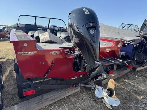Slide: The Image of 2025 Tracker Targa V-18 WT boat with outboard motor, red exterior, parked on trailer. - 4