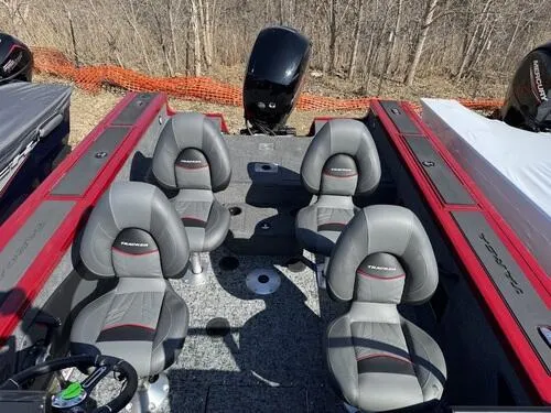 Slide: The Image of 2025 Tracker Targa V-18 WT boat interior with four gray seats and red accents. - 6