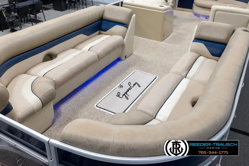 Slide: The Image of 2012 Cypress Cay 250 Cozumel pontoon boat interior with beige seating and blue accents. - 10